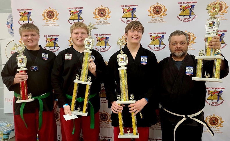 Joey, charlie, Kevin, and Ben posing with their trophies