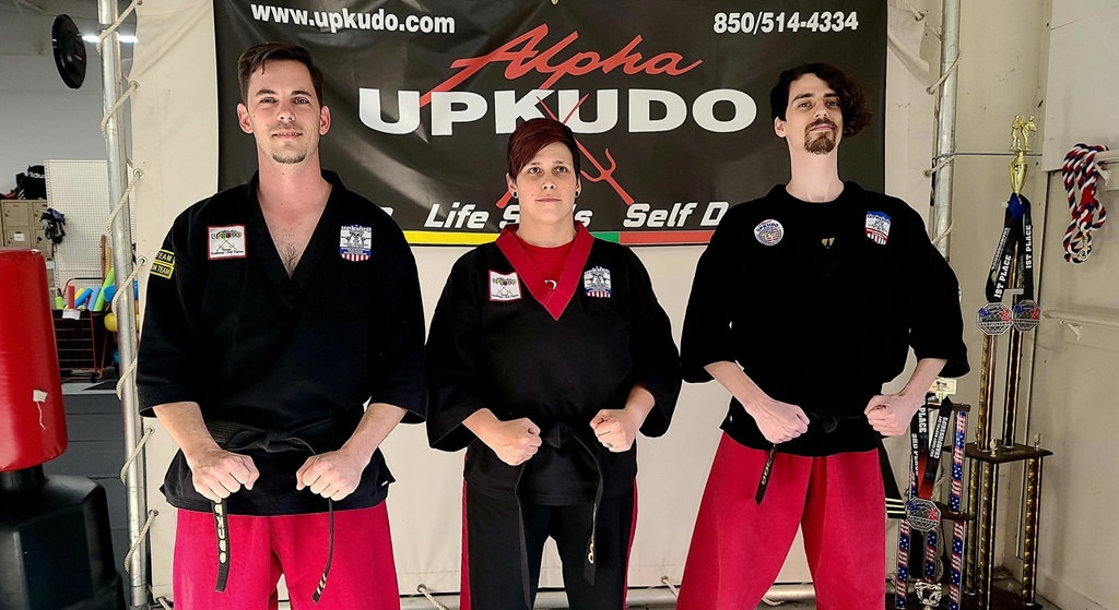 Sarah, Justin, and Daniel pose in their uniforms with their new ranks